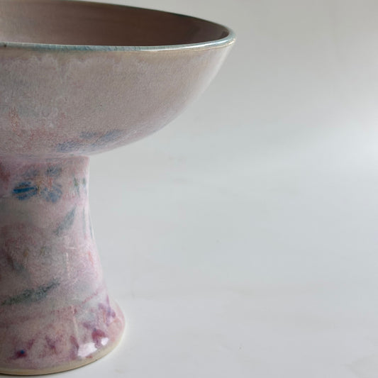 Ceramic vase with floral patterns on a plain background
