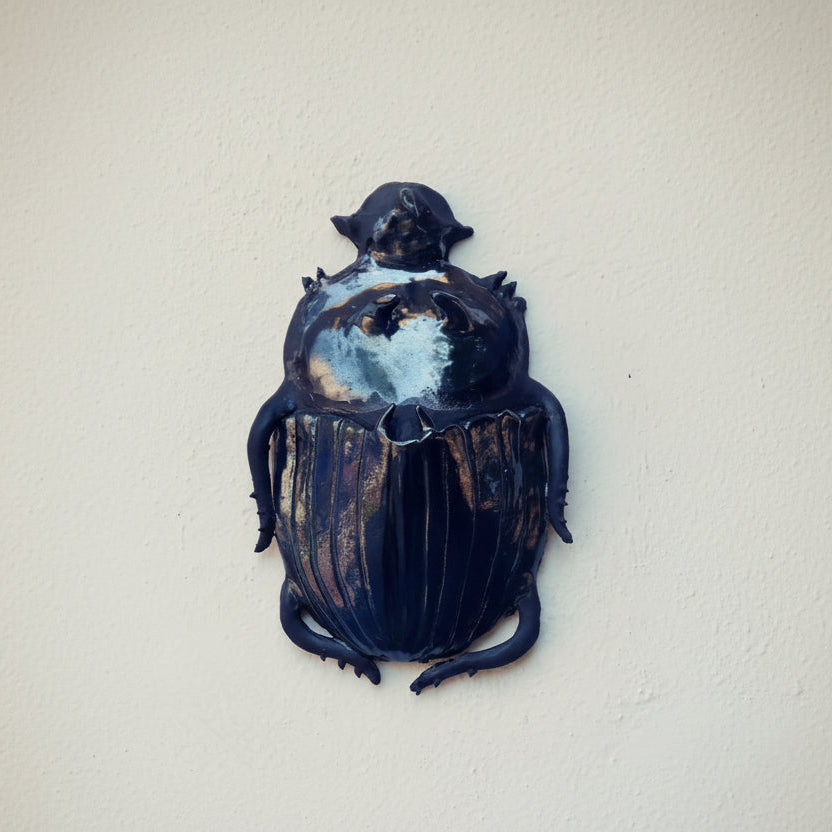 Decorative beetle sculpture on a white background