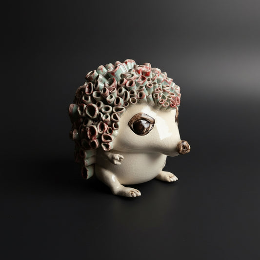 Decorative ceramic hedgehog with textured shell on a dark background