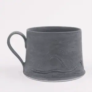 Gray ceramic mug with textured design on a white background